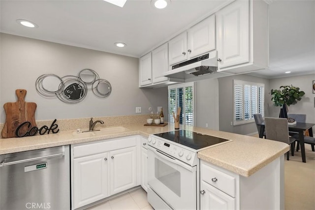 kitchen featuring a sink, a peninsula, stainless steel dishwasher, under cabinet range hood, and white electric stove