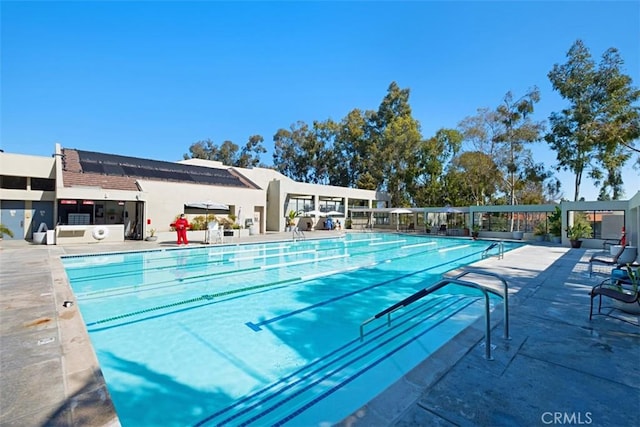 community pool with a patio area
