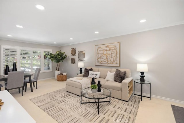living room with crown molding, baseboards, recessed lighting, and light colored carpet
