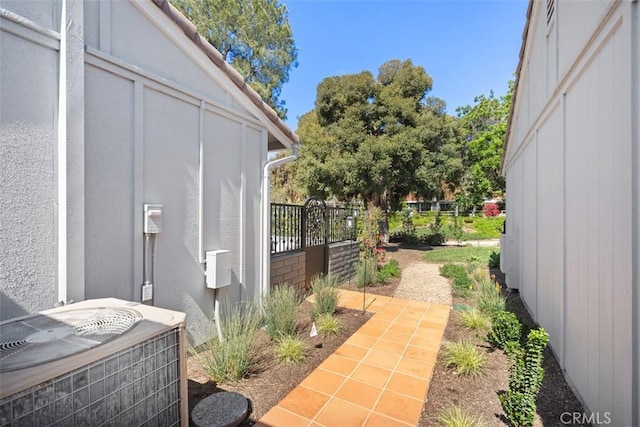 exterior space featuring central AC unit and fence