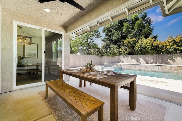 view of patio / terrace with a fenced in pool, a ceiling fan, outdoor dining area, and a fenced backyard