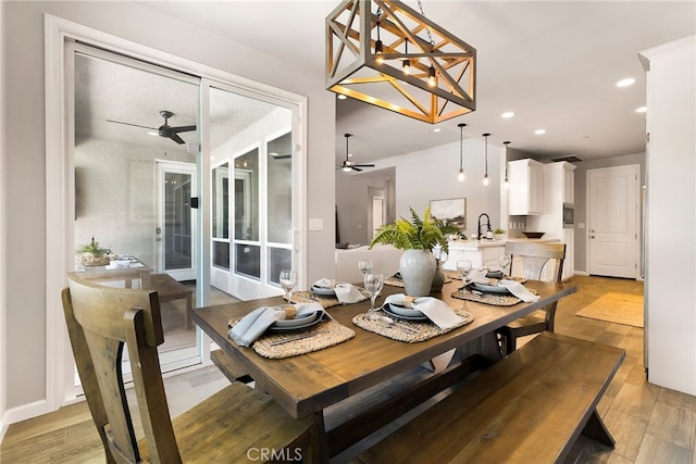 dining room featuring ceiling fan, recessed lighting, baseboards, and light wood-style floors