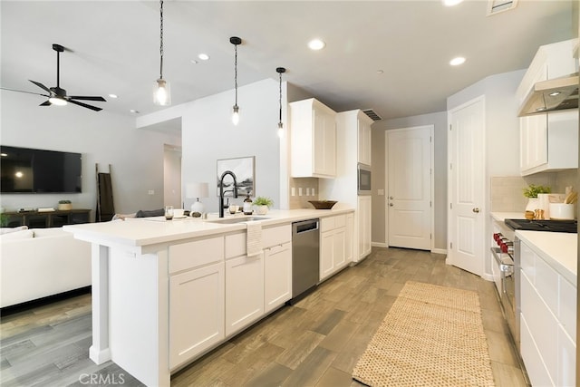 2617 Sedona Ave, Chico, CA 95973 - kitchen featuring a sink, appliances with stainless steel finishes, a peninsula, open floor plan, and white cabinetry