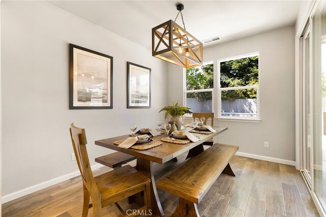 2617 Sedona Ave, Chico, CA 95973 - dining room featuring a chandelier, light wood-style flooring, and baseboards