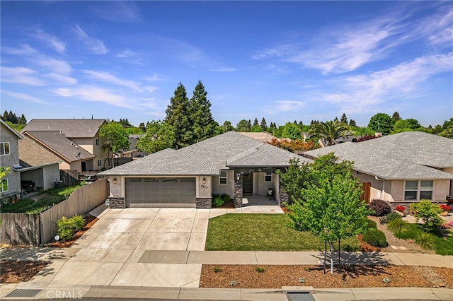 view of front facade with a garage, stone siding, concrete driveway, stucco siding, and fence