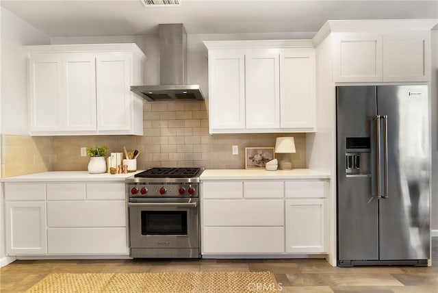 2617 Sedona Ave, Chico, CA 95973 - kitchen with high end appliances, wall chimney exhaust hood, light countertops, and white cabinetry