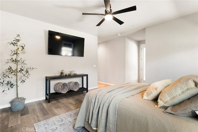 bedroom with wood finished floors, ceiling fan, and baseboards