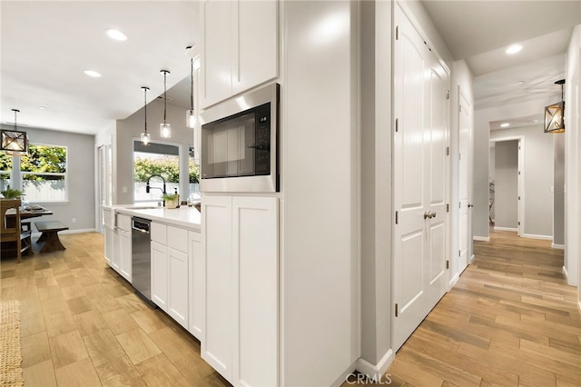 2617 Sedona Ave, Chico, CA 95973 - kitchen with stainless steel appliances, a sink, recessed lighting, baseboards, and light wood-style flooring