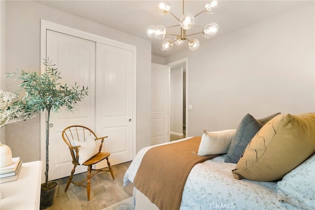 2617 Sedona Ave, Chico, CA 95973 - bedroom with light wood-type flooring, a chandelier, and a closet