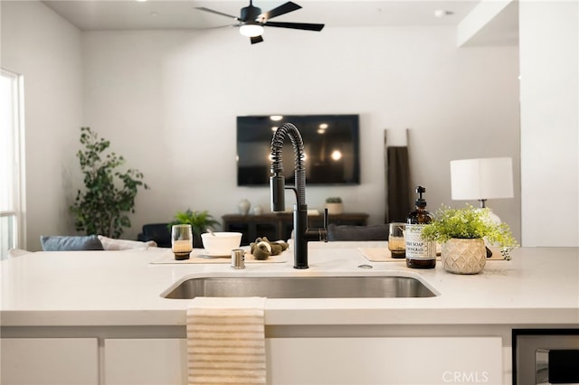 2617 Sedona Ave, Chico, CA 95973 - kitchen featuring open floor plan, a sink, light countertops, ceiling fan, and white cabinetry