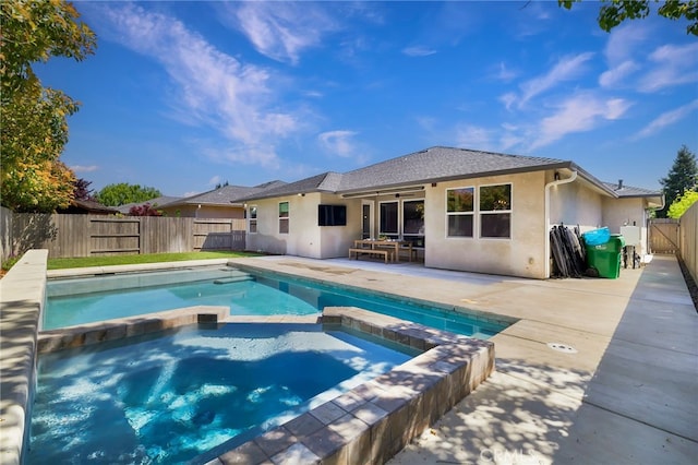 view of pool with a pool with connected hot tub, a patio, a fenced backyard, and a gate