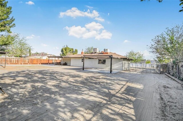 back of property featuring fence, stucco siding, and a patio area