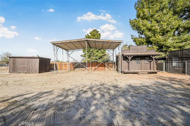 view of yard with fence, an outdoor structure, and a detached carport