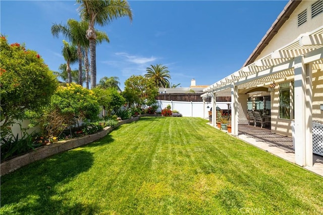 view of yard with a fenced backyard, a pergola, and a patio area