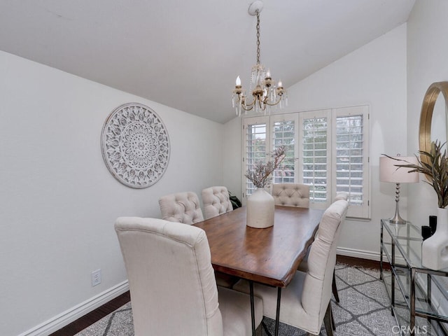 dining area with wood finished floors, lofted ceiling, and baseboards