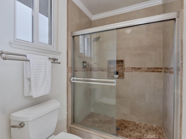 full bath with toilet, ornamental molding, and a stall shower