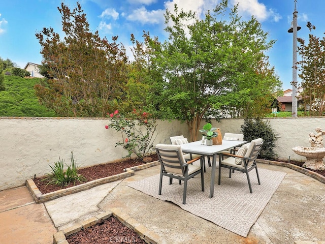 view of patio / terrace featuring fence private yard and outdoor dining area