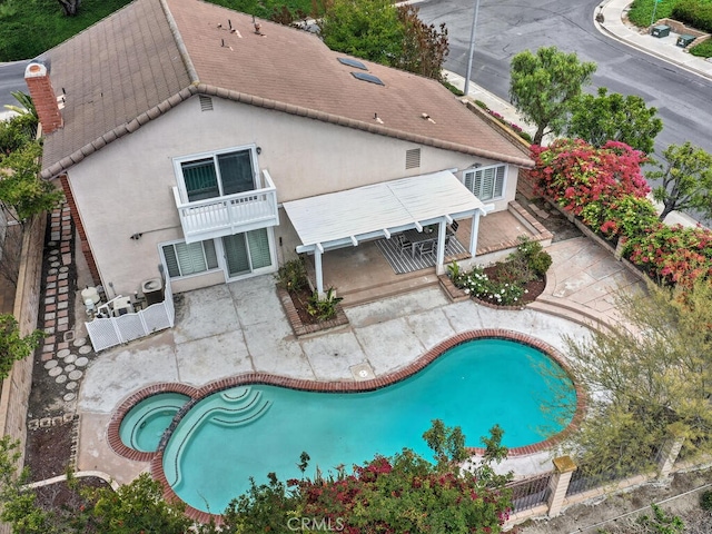 exterior space with a patio, fence, and a hot tub