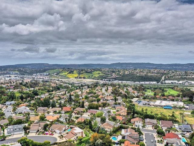 birds eye view of property with a mountain view and a residential view