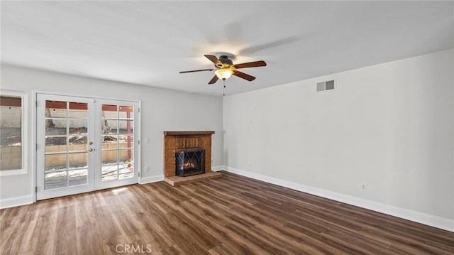 unfurnished living room with visible vents, wood finished floors, baseboards, french doors, and a ceiling fan
