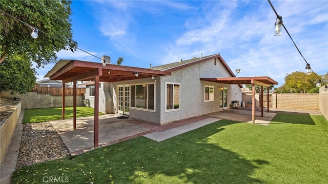 back of property featuring a lawn, a patio, a fenced backyard, and stucco siding