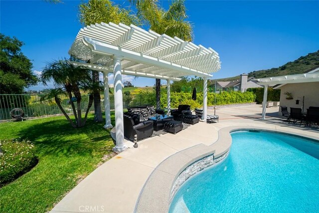 view of swimming pool featuring fence, a pergola, a fenced in pool, a patio, and a yard