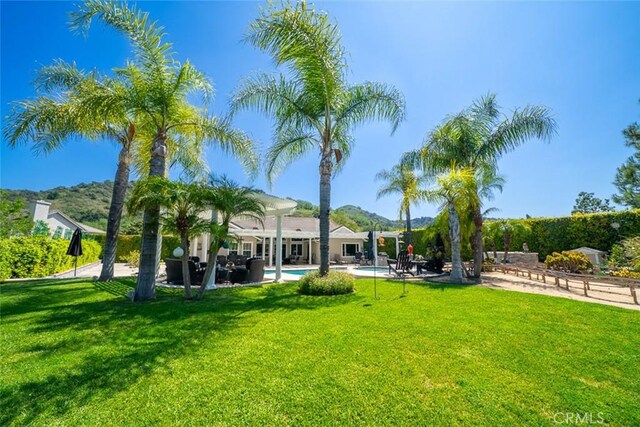 view of yard with an outdoor pool and a patio area