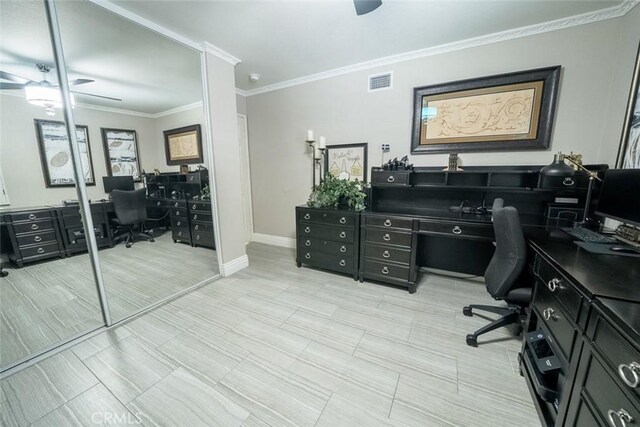 office area featuring a ceiling fan, baseboards, visible vents, and ornamental molding