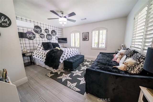 bedroom with baseboards, visible vents, and ceiling fan