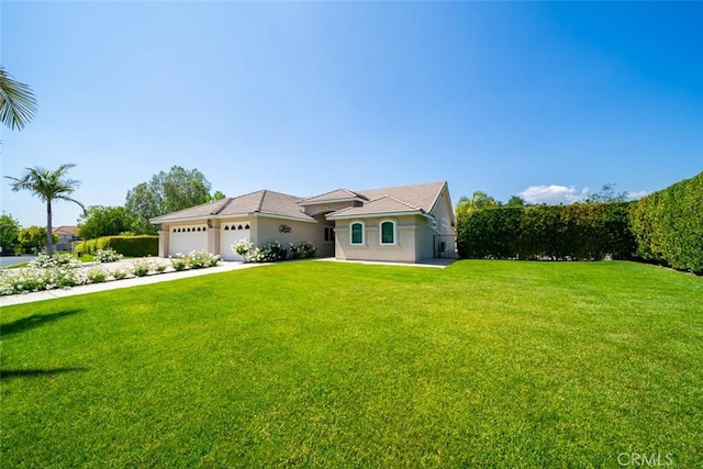 view of front facade featuring an attached garage, concrete driveway, stucco siding, and a front lawn
