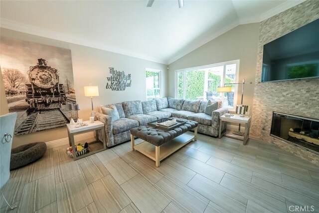 living area featuring ornamental molding, high vaulted ceiling, wood finished floors, and a fireplace