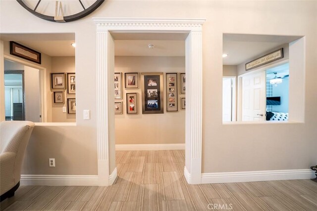 hall featuring baseboards and wood finished floors