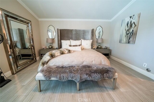 bedroom featuring baseboards, ornamental molding, and wood finished floors