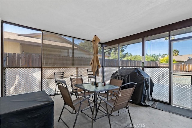 sunroom / solarium featuring outdoor dining area