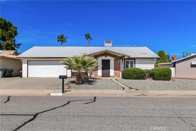27680 Sandtrap Dr, Menifee, CA 92586 - view of front of property with an attached garage, driveway, and brick siding