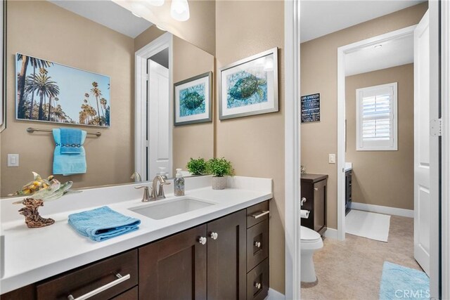21609 Lucas Ct, Saugus, CA 91390 - bathroom featuring vanity, baseboards, and toilet