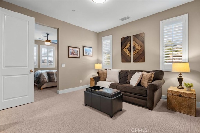 21609 Lucas Ct, Saugus, CA 91390 - living room with visible vents, a ceiling fan, baseboards, and light colored carpet