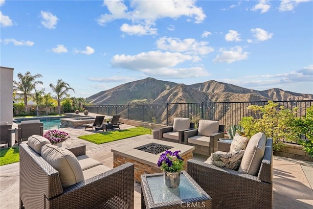 21609 Lucas Ct, Saugus, CA 91390 - view of patio featuring a pool with connected hot tub, a mountain view, a fenced backyard, and an outdoor living space with a fire pit