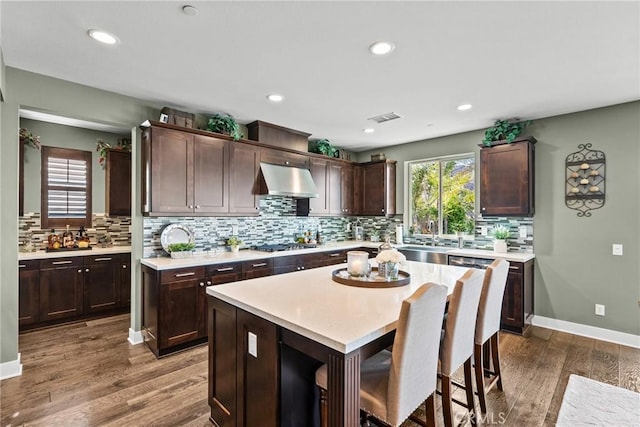 21609 Lucas Ct, Saugus, CA 91390 - kitchen featuring a sink, light countertops, backsplash, and dark brown cabinets