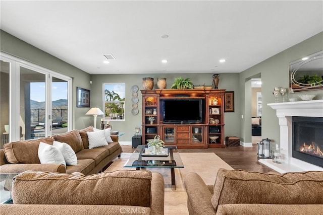 21609 Lucas Ct, Saugus, CA 91390 - living area with visible vents, a glass covered fireplace, wood finished floors, baseboards, and recessed lighting