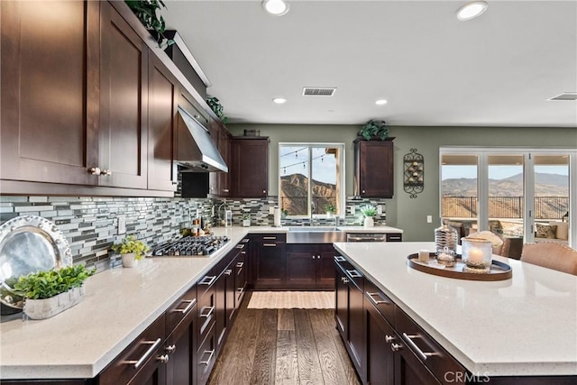 21609 Lucas Ct, Saugus, CA 91390 - kitchen with backsplash, dark wood-style flooring, stainless steel gas cooktop, a sink, and recessed lighting