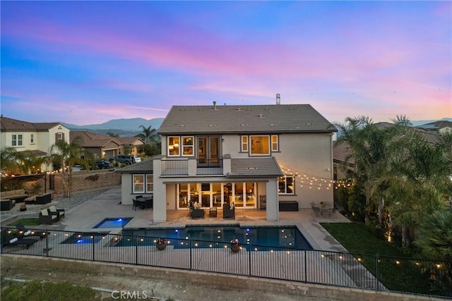 21609 Lucas Ct, Saugus, CA 91390 - rear view of house featuring a patio, stucco siding, an outdoor living space, and a balcony
