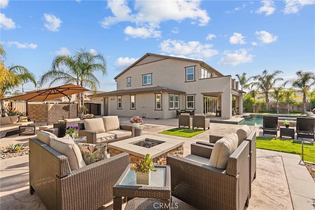21609 Lucas Ct, Saugus, CA 91390 - back of property featuring a fenced in pool, an outdoor living space with a fire pit, a patio area, and stucco siding