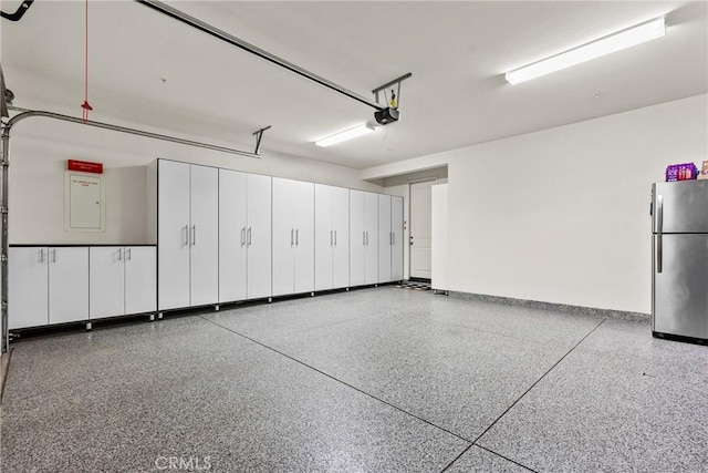 21609 Lucas Ct, Saugus, CA 91390 - garage featuring a garage door opener and freestanding refrigerator