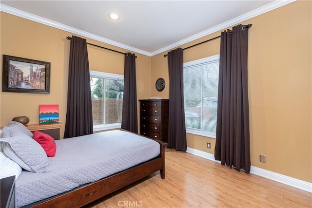 bedroom featuring ornamental molding, recessed lighting, light wood-style flooring, and baseboards