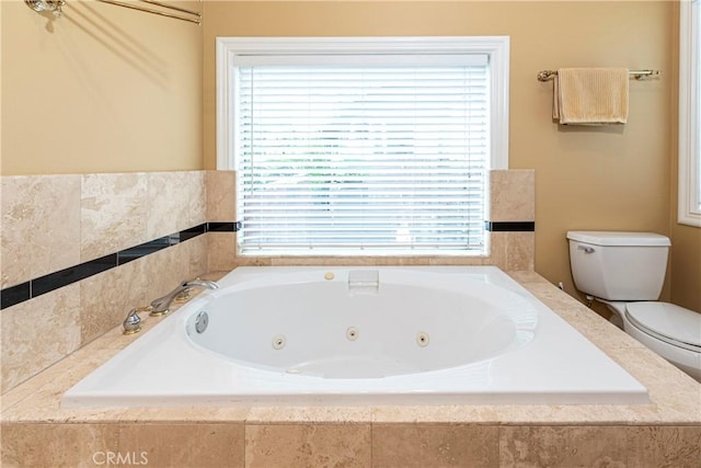full bath featuring toilet and a jetted tub