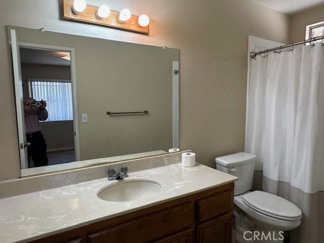 bathroom with toilet and vanity