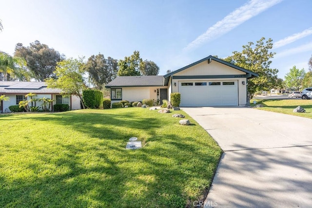 single story home featuring a front lawn, concrete driveway, and an attached garage