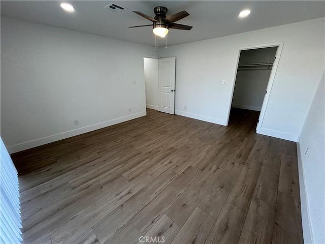 unfurnished bedroom with dark wood-style flooring, visible vents, recessed lighting, and baseboards