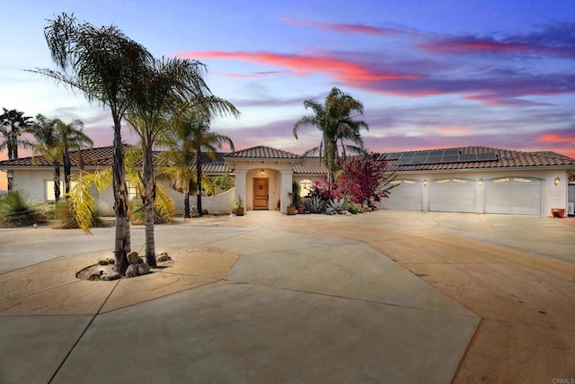25444 Rancho Barona Rd, Ramona, CA 92065 - mediterranean / spanish home featuring concrete driveway, roof mounted solar panels, a tiled roof, and stucco siding